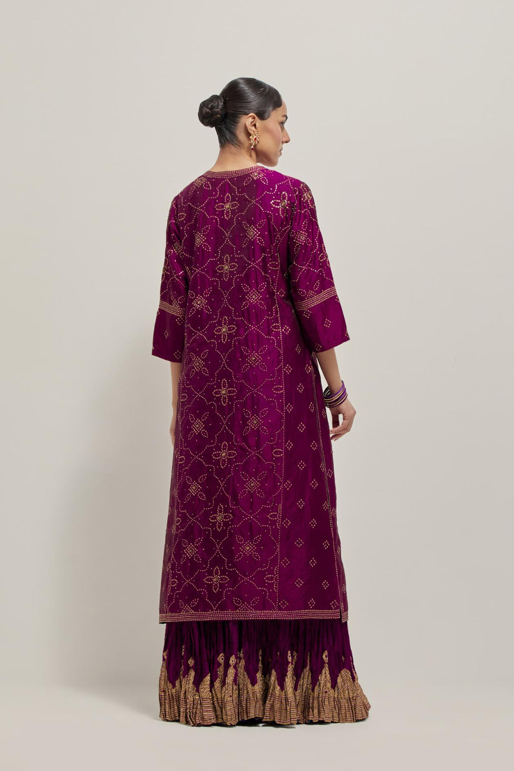 Wine Silk kurta set with all-over hand embroidered sequins on bandhani inspired floral jaal and small square booti at side panels, highlighted with contrast-colored beads.