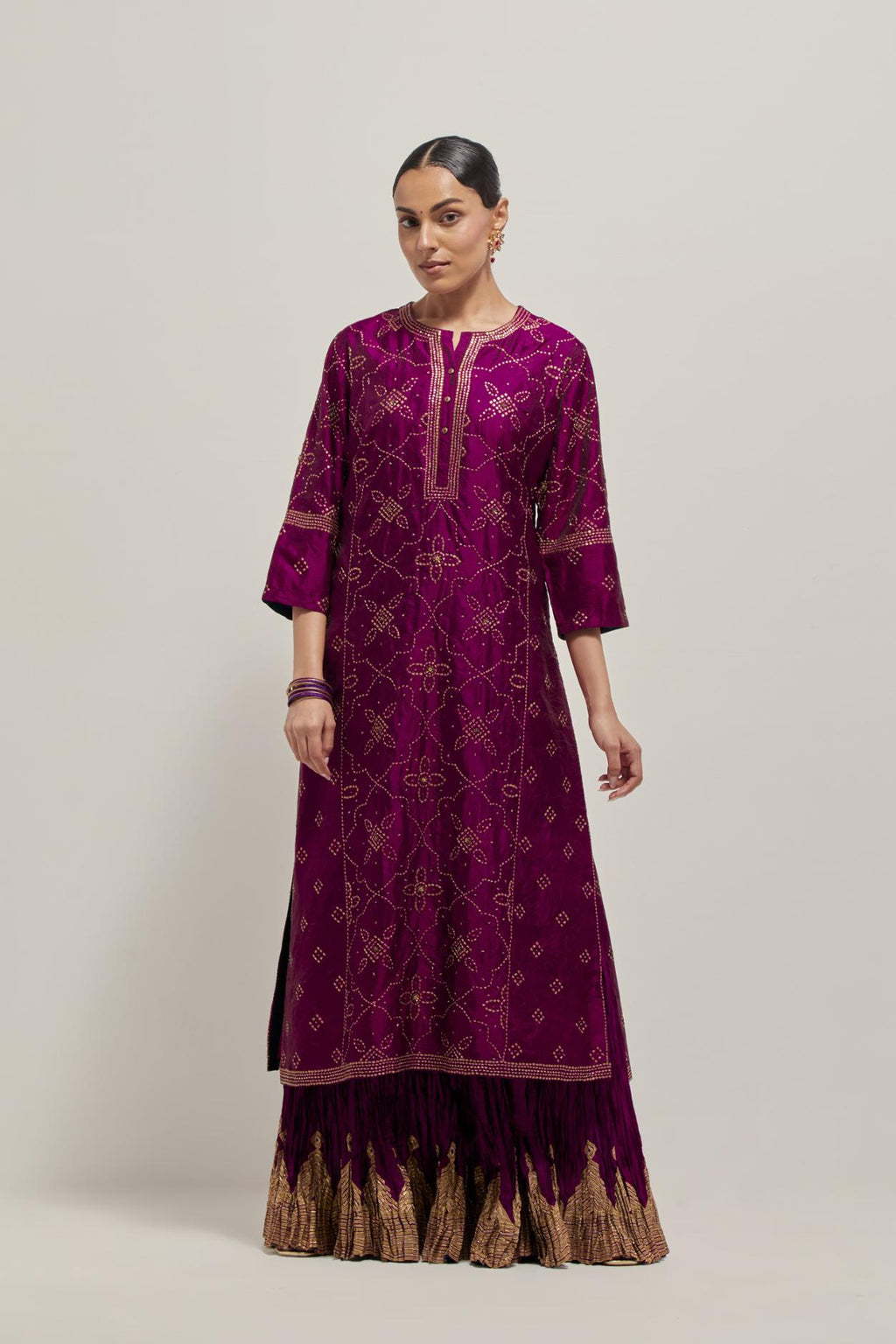 Wine Silk kurta set with all-over hand embroidered sequins on bandhani inspired floral jaal and small square booti at side panels, highlighted with contrast-colored beads.