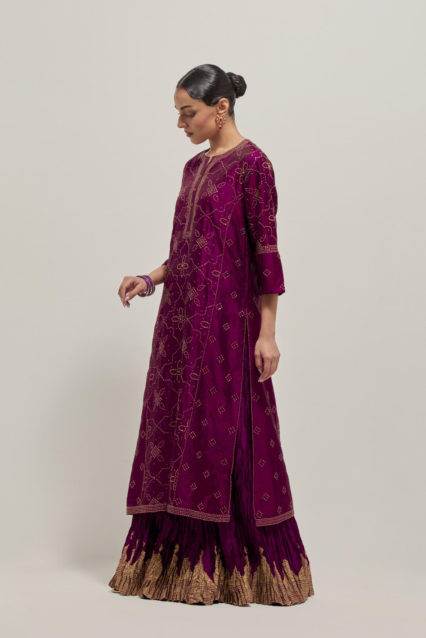 Wine Silk kurta set with all-over hand embroidered sequins on bandhani inspired floral jaal and small square booti at side panels, highlighted with contrast-colored beads.