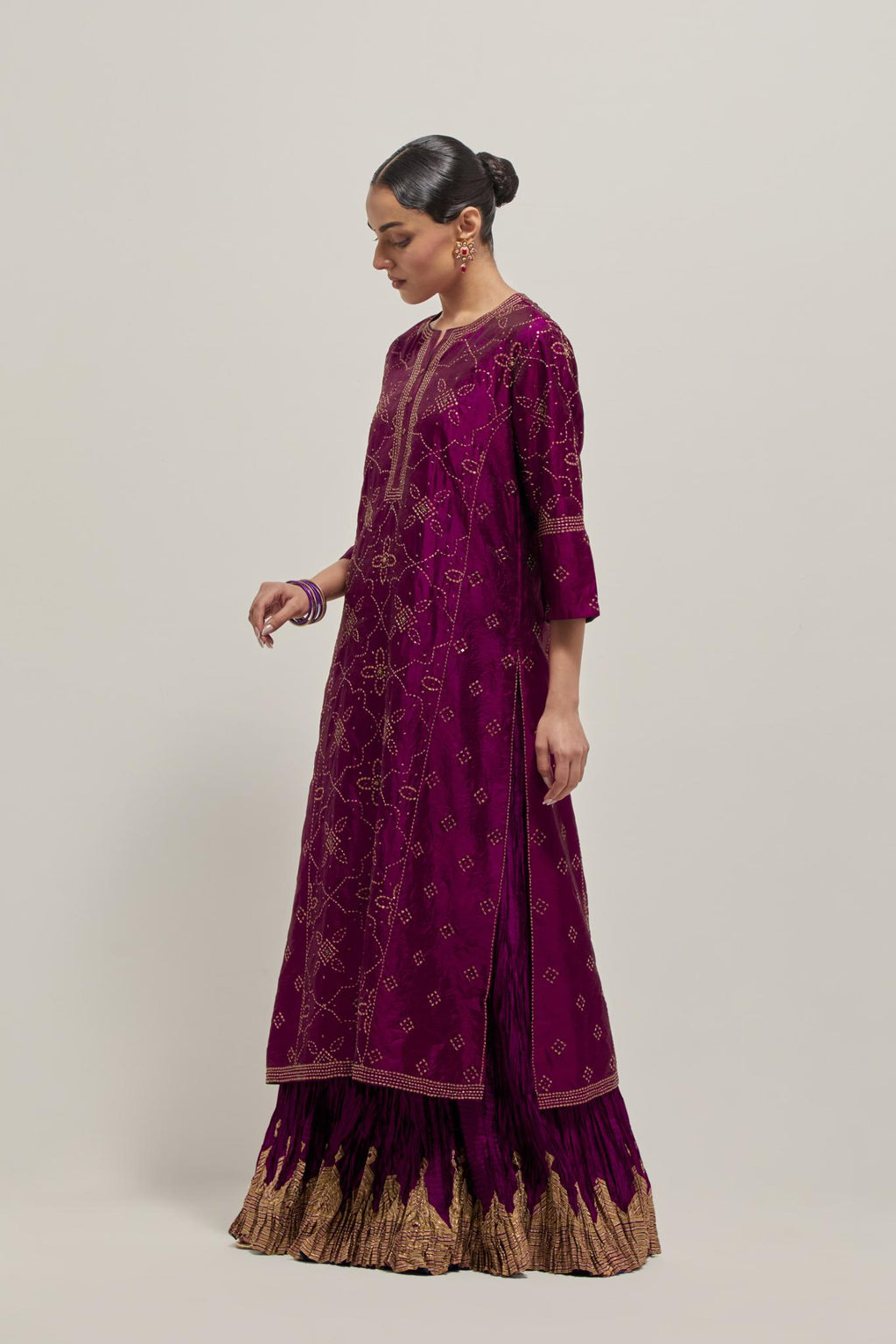 Wine Silk kurta set with all-over hand embroidered sequins on bandhani inspired floral jaal and small square booti at side panels, highlighted with contrast-colored beads.