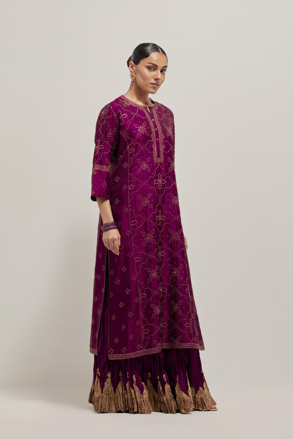 Wine Silk kurta set with all-over hand embroidered sequins on bandhani inspired floral jaal and small square booti at side panels, highlighted with contrast-colored beads.