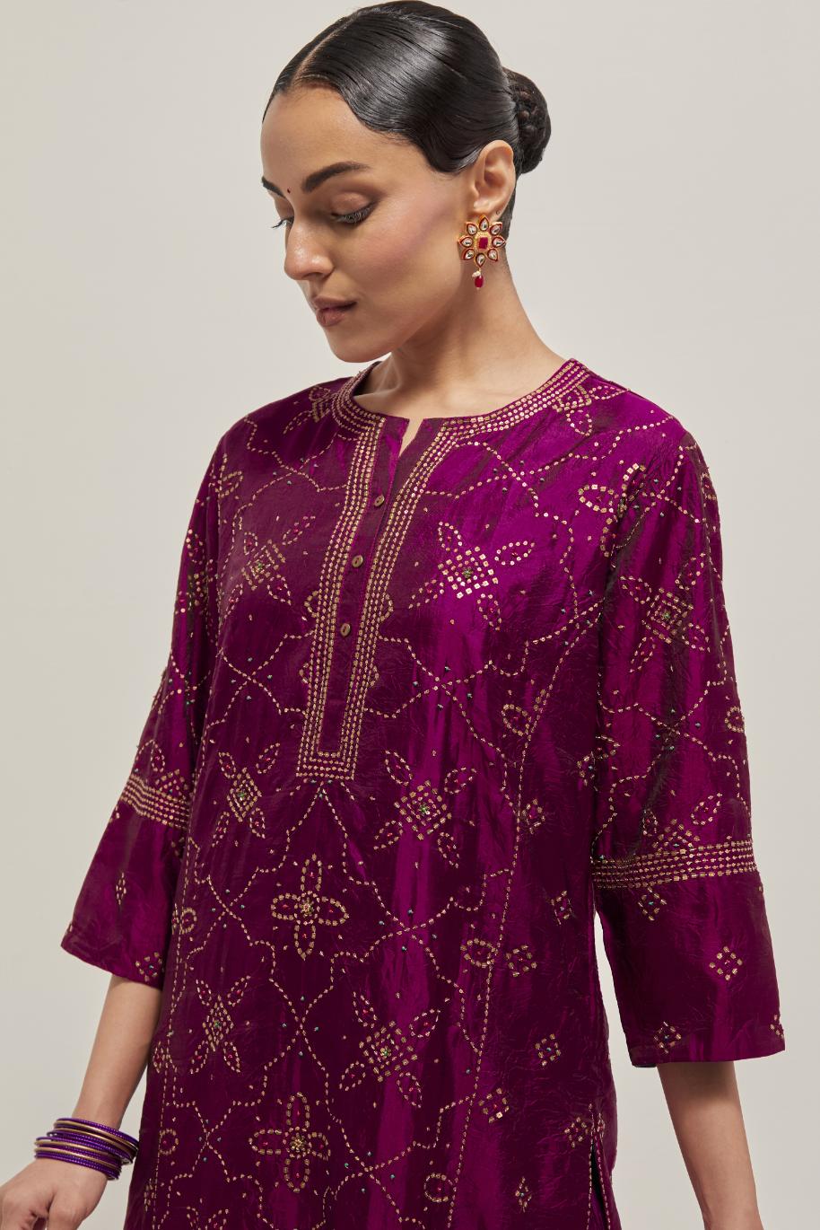 Wine Silk kurta set with all-over hand embroidered sequins on bandhani inspired floral jaal and small square booti at side panels, highlighted with contrast-colored beads.