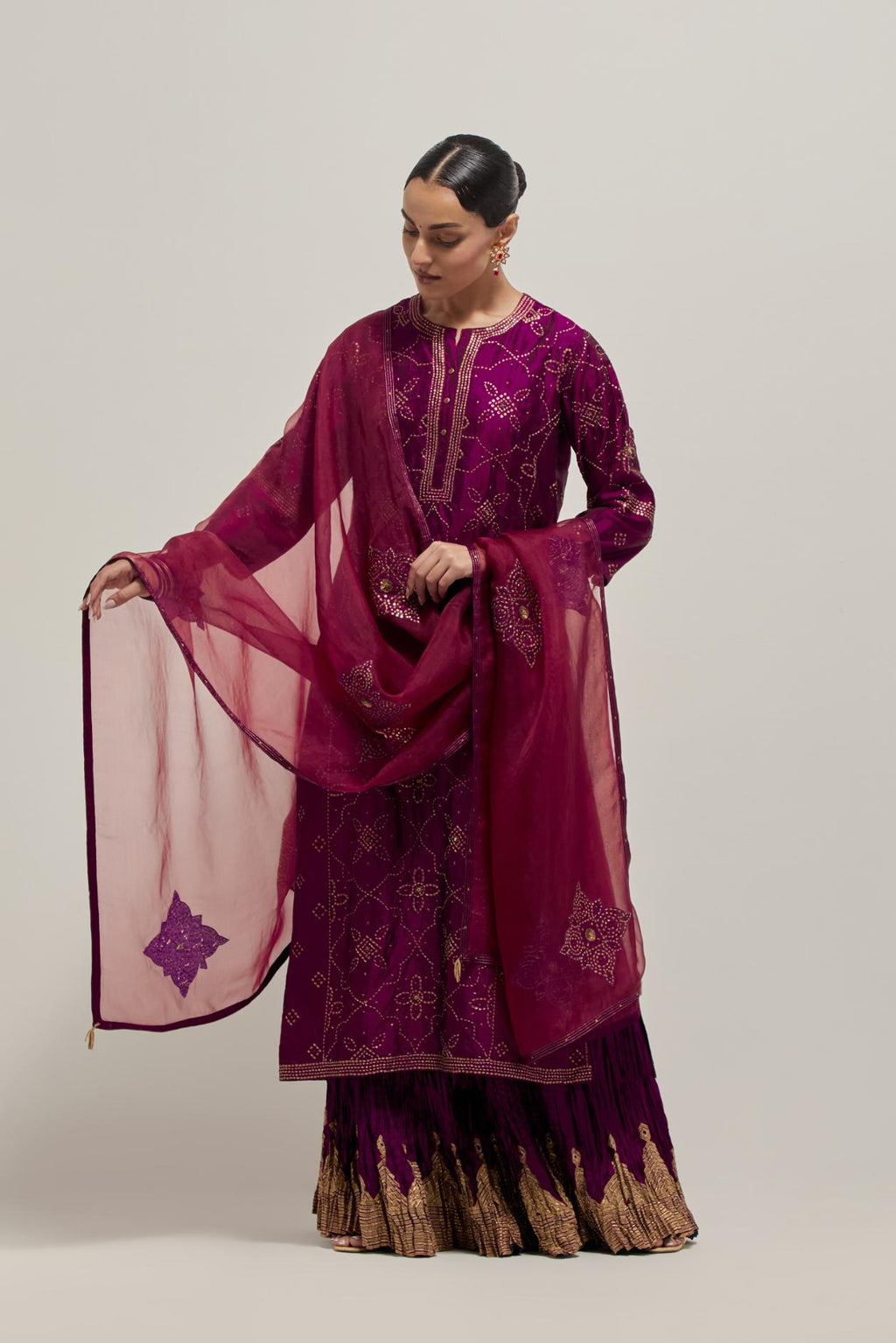Wine Silk kurta set with all-over hand embroidered sequins on bandhani inspired floral jaal and small square booti at side panels, highlighted with contrast-colored beads.