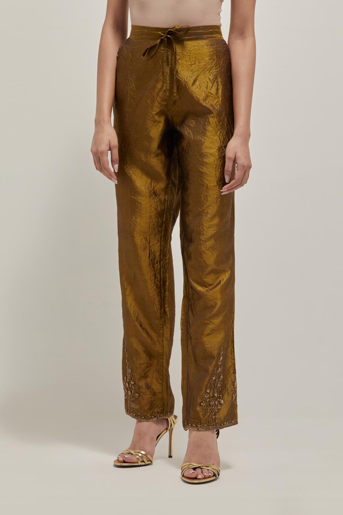 Olive Silk pants, highlighted with hand embroidered bead, sequins and zardozi boota at hem, highlighted with contrast bead work.