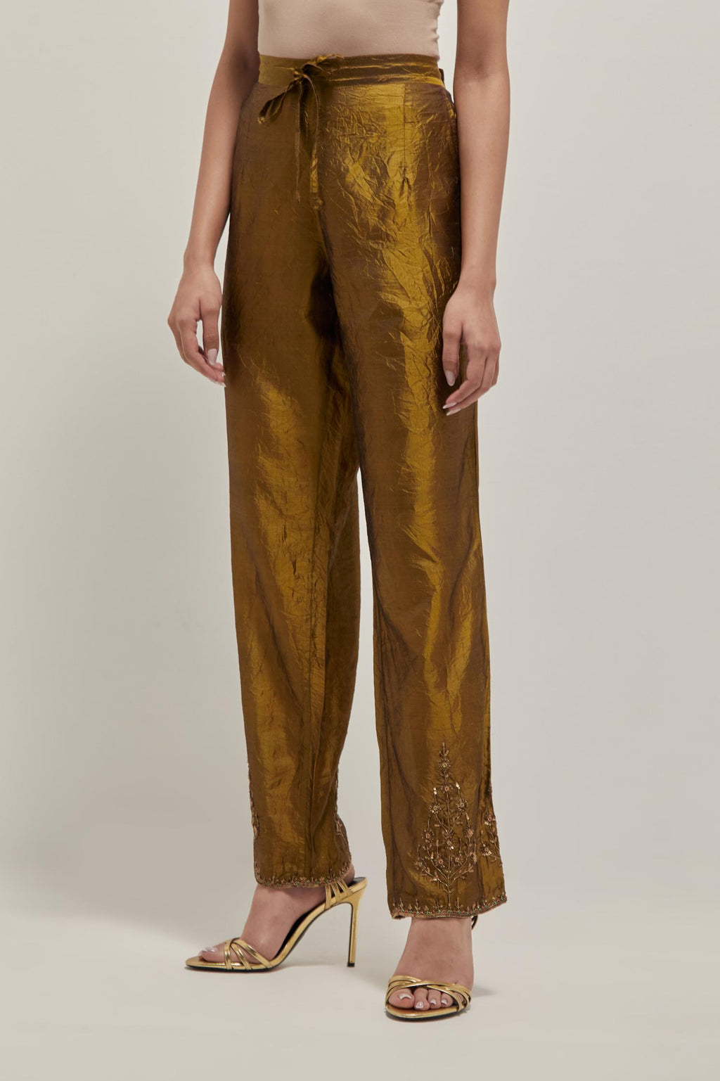 Olive Silk pants, highlighted with hand embroidered bead, sequins and zardozi boota at hem, highlighted with contrast bead work.