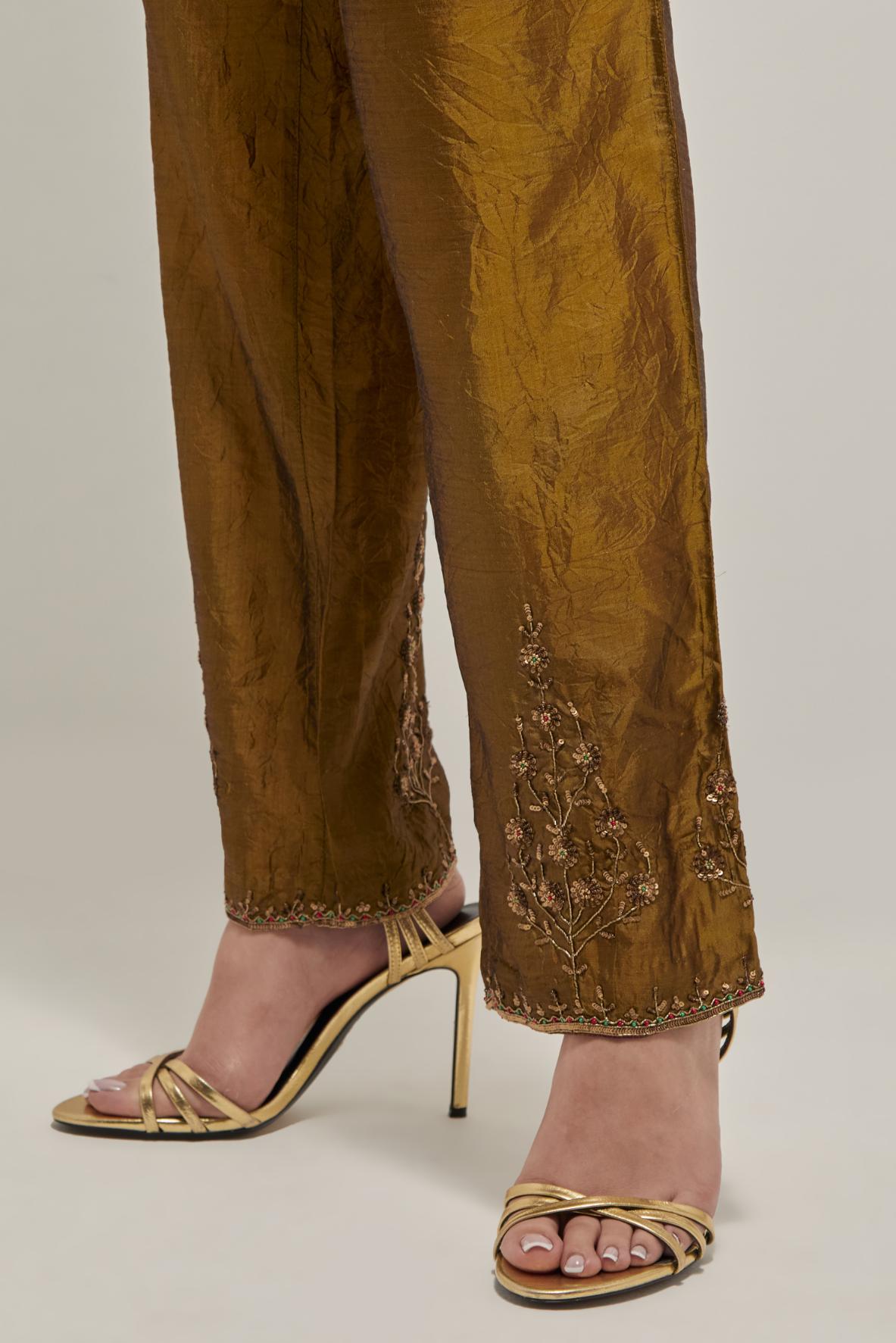 Olive Silk pants, highlighted with hand embroidered bead, sequins and zardozi boota at hem, highlighted with contrast bead work.