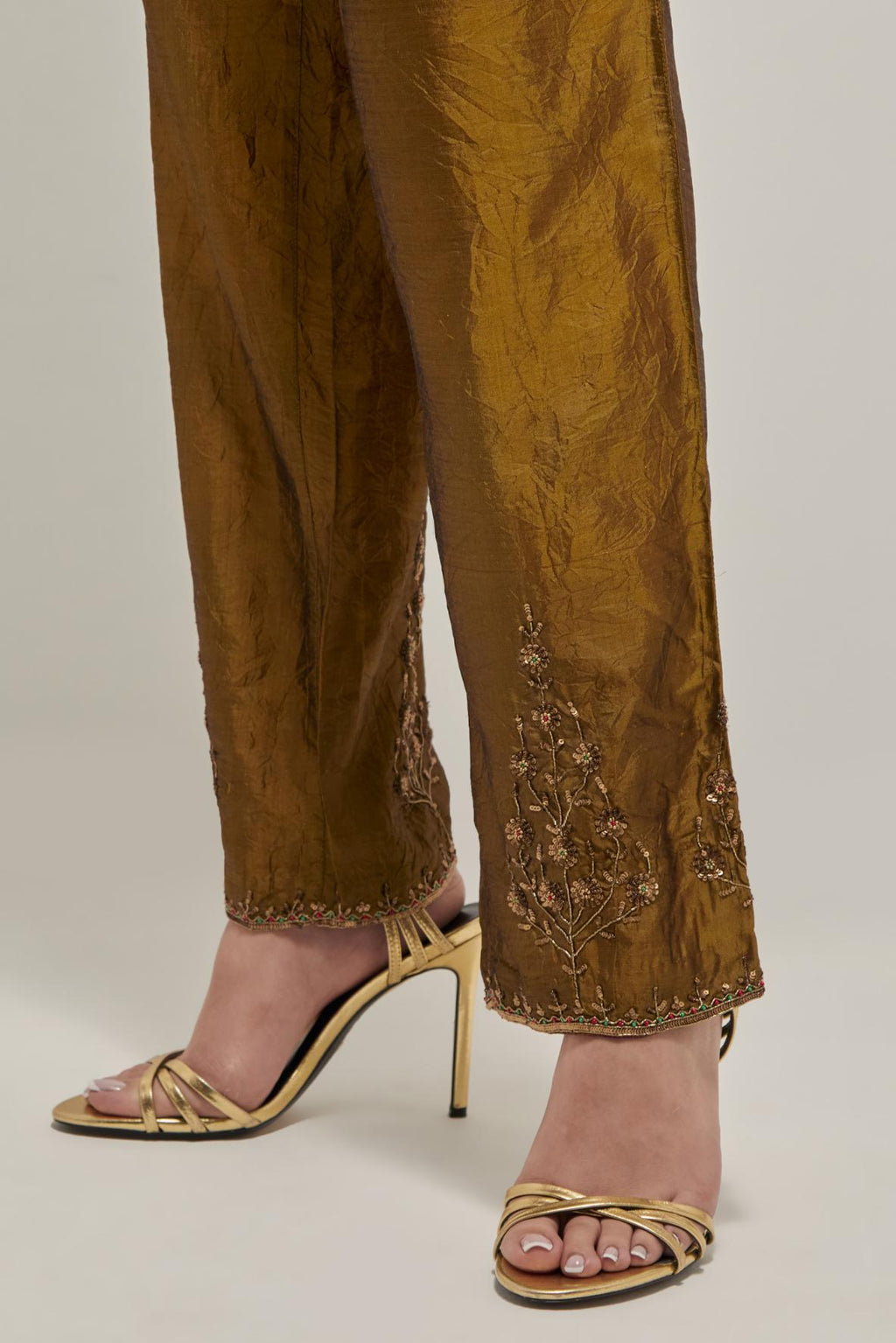 Olive Silk pants, highlighted with hand embroidered bead, sequins and zardozi boota at hem, highlighted with contrast bead work.