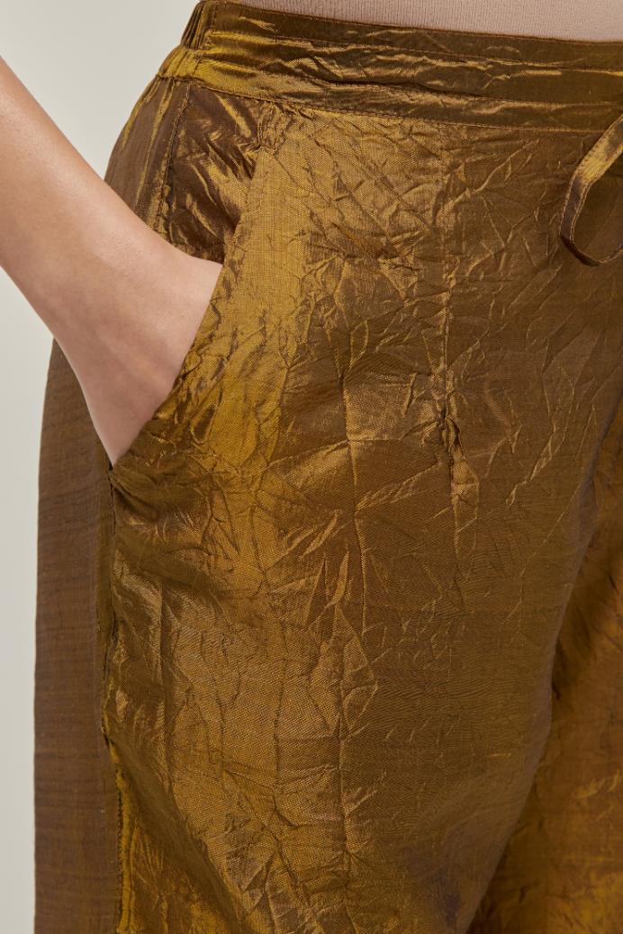 Olive Silk pants, highlighted with hand embroidered bead, sequins and zardozi boota at hem, highlighted with contrast bead work.