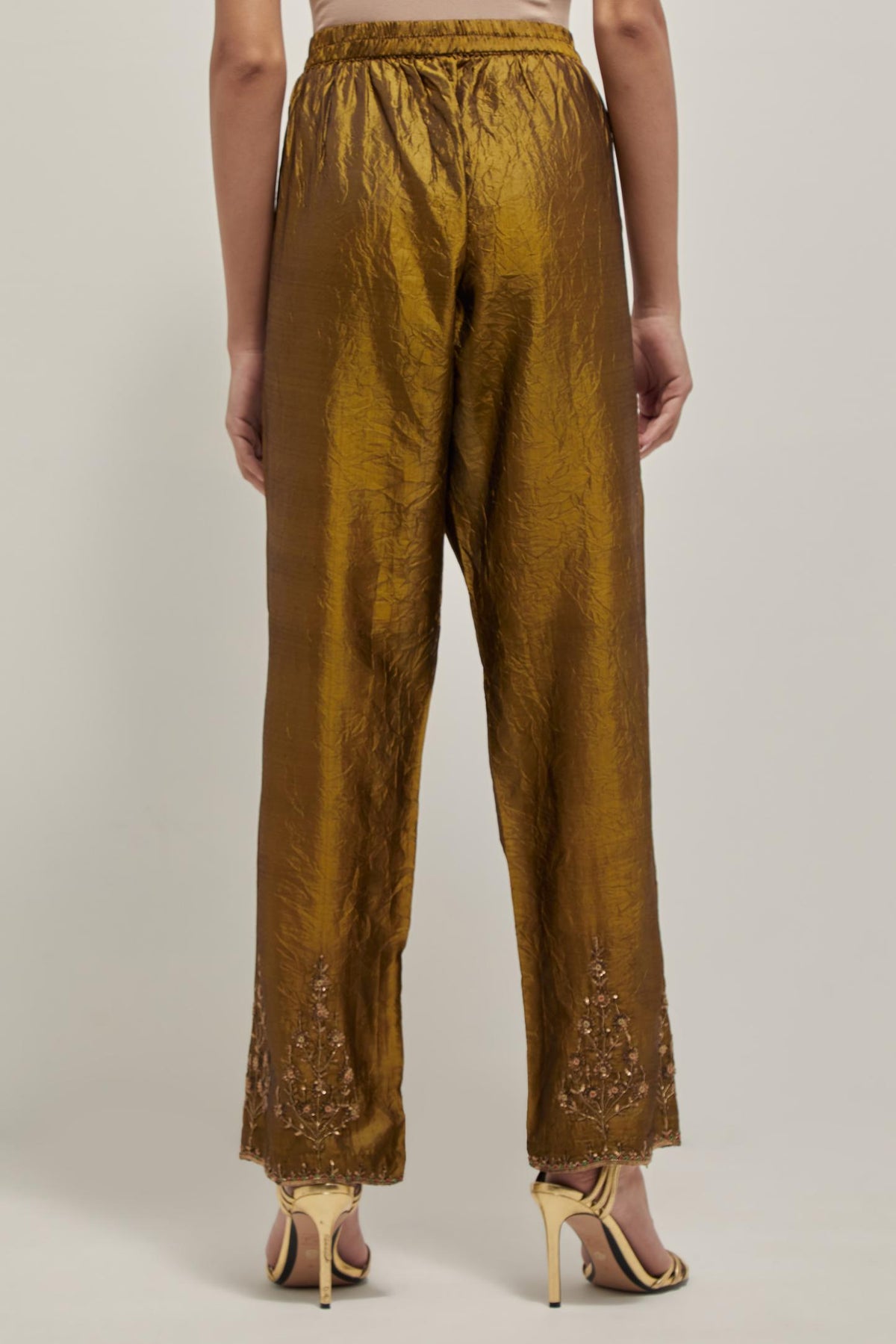 Olive Silk pants, highlighted with hand embroidered bead, sequins and zardozi boota at hem, highlighted with contrast bead work.