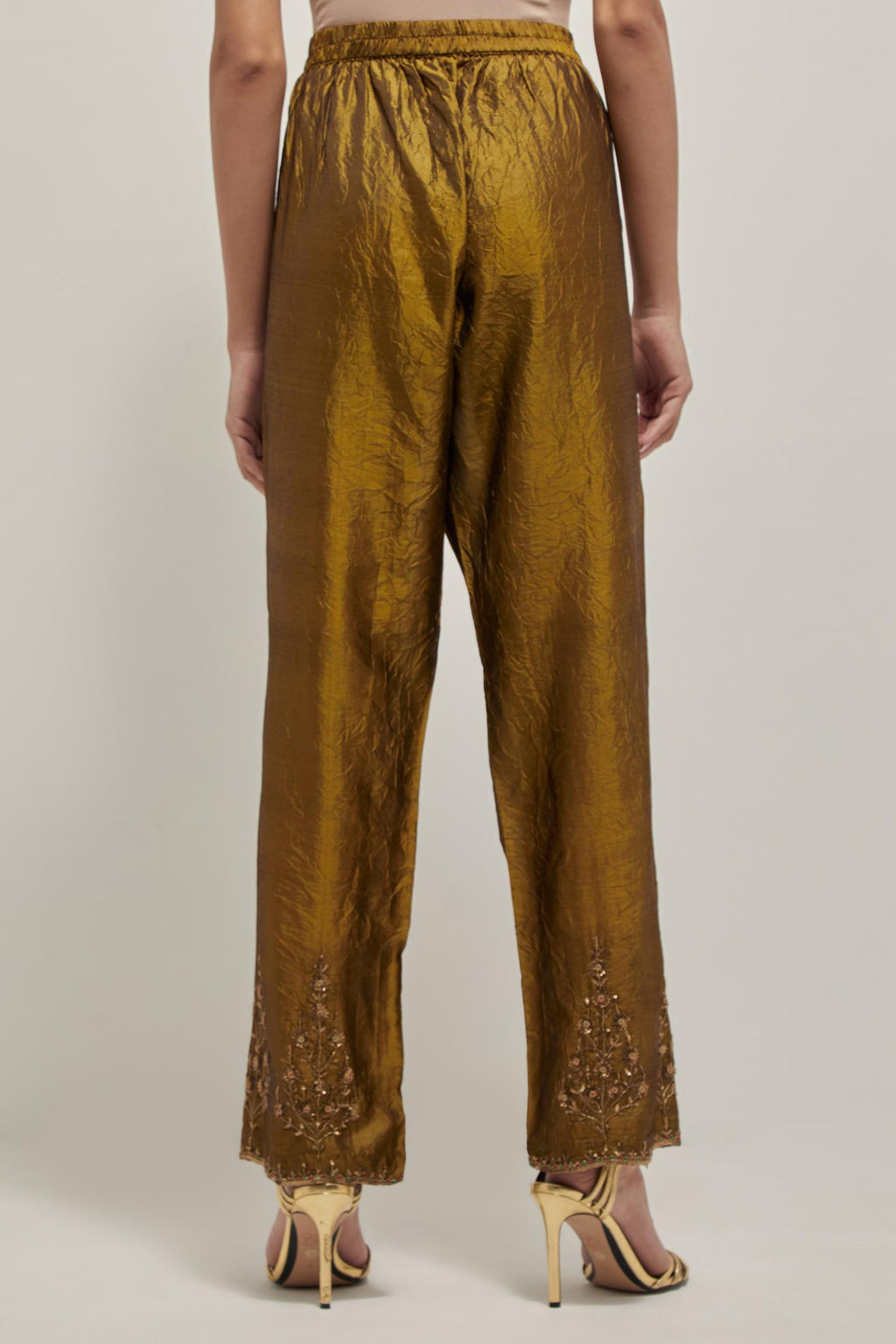 Olive Silk pants, highlighted with hand embroidered bead, sequins and zardozi boota at hem, highlighted with contrast bead work.