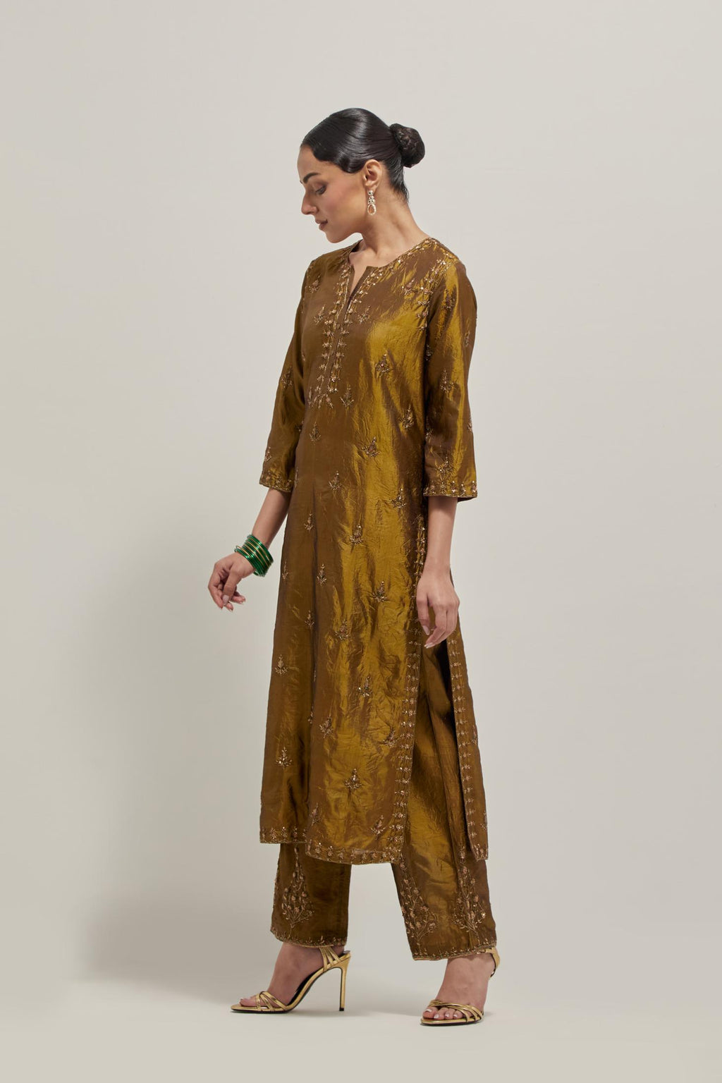Olive double toned silk straight kurta set with all-over hand embroidered zardozi and sequins work, highlighted with beads.
