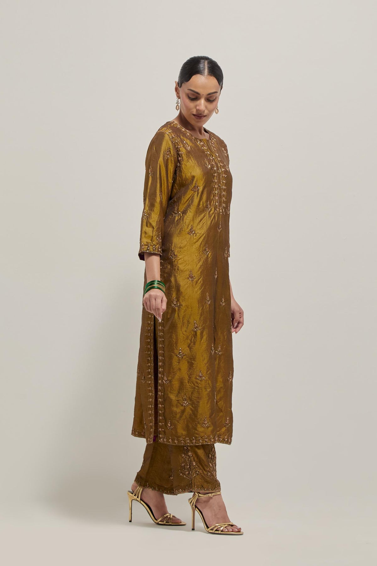 Olive double toned silk straight kurta set with all-over hand embroidered zardozi and sequins work, highlighted with beads.