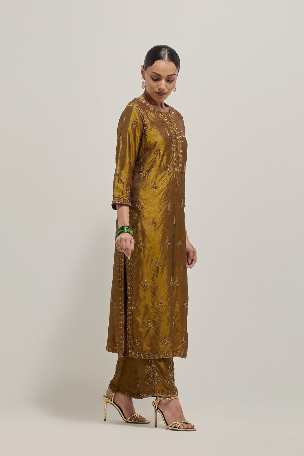 Olive double toned silk straight kurta set with all-over hand embroidered zardozi and sequins work, highlighted with beads.