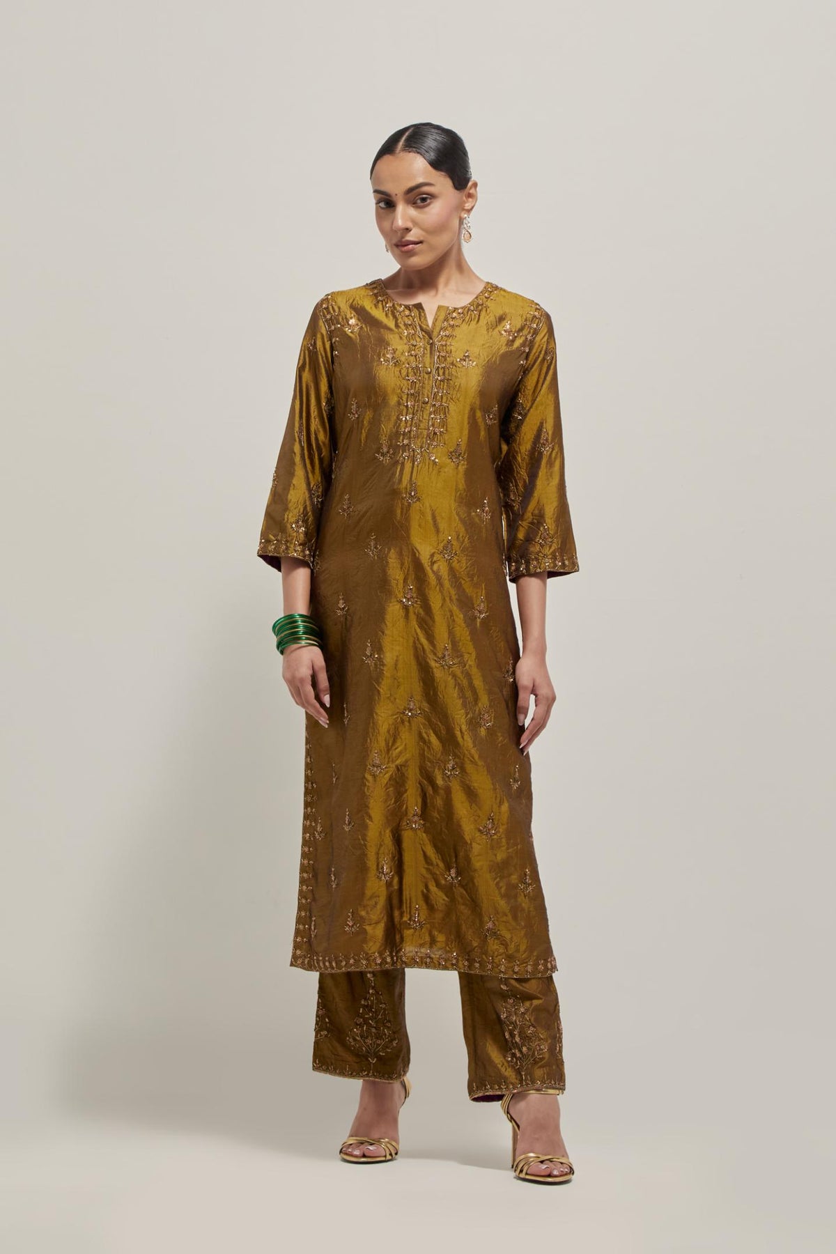 Olive double toned silk straight kurta set with all-over hand embroidered zardozi and sequins work, highlighted with beads.