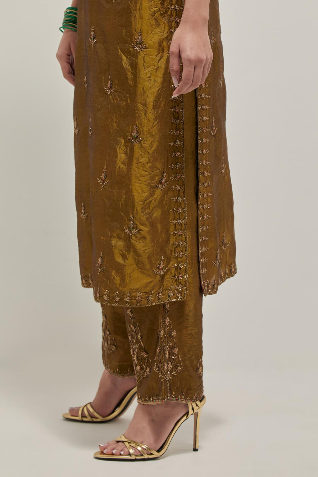 Olive double toned silk straight kurta set with all-over hand embroidered zardozi and sequins work, highlighted with beads.