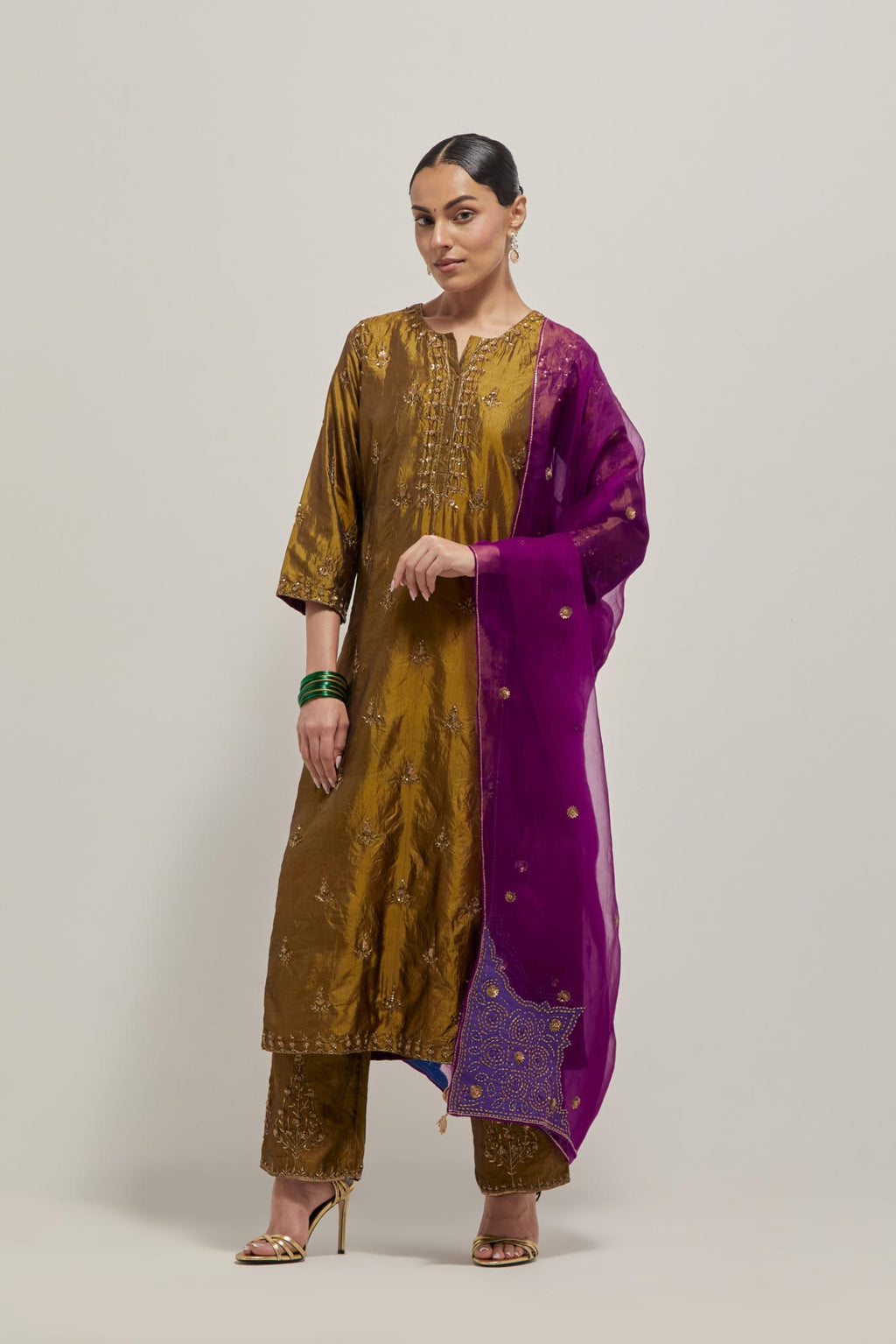 Olive double toned silk straight kurta set with all-over hand embroidered zardozi and sequins work, highlighted with beads.