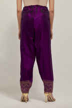 Purple silk narrow salwar with a broad bandhani-inspired border at the hem, detailed with delicate bead and sequin work.