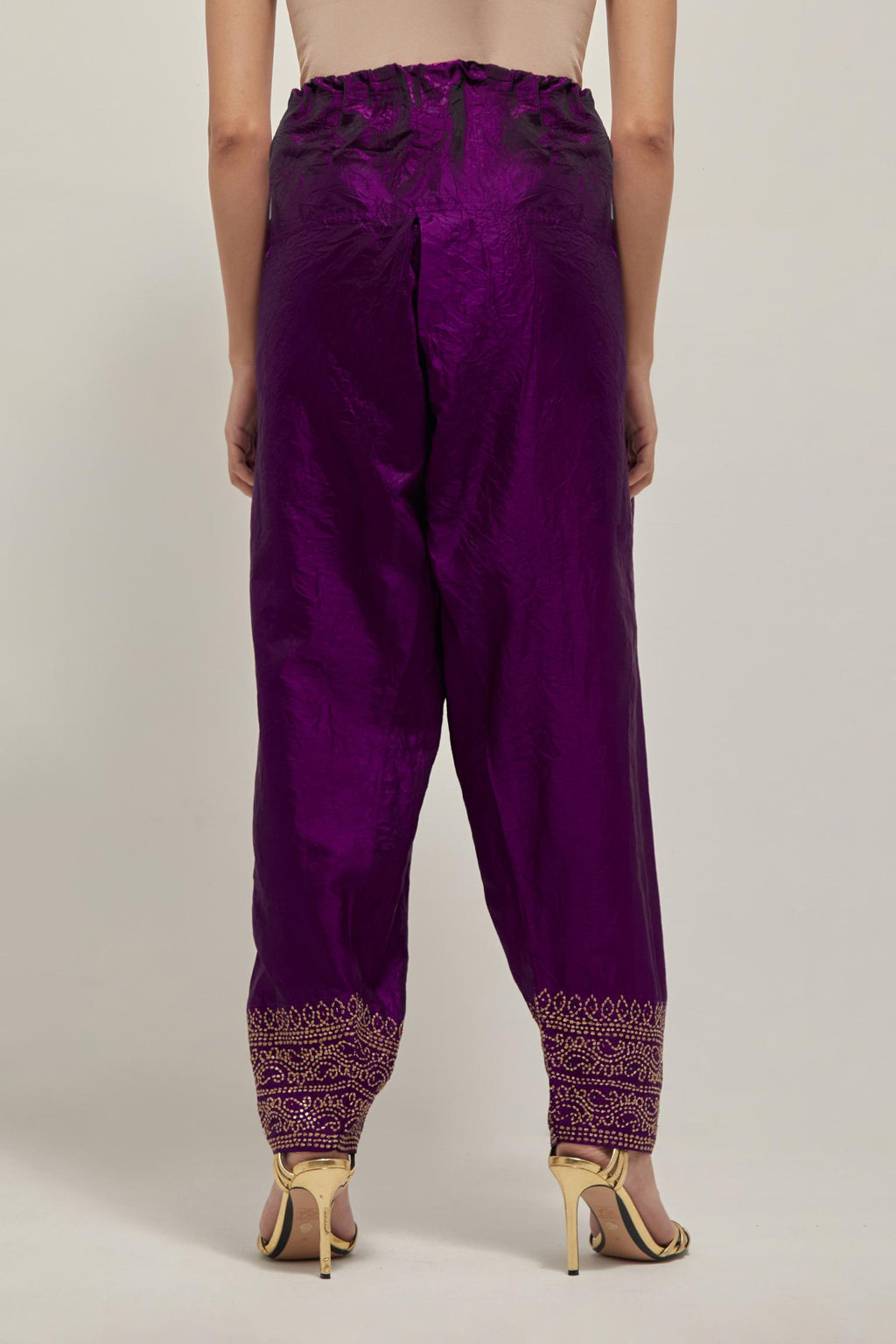 Purple silk narrow salwar with a broad bandhani-inspired border at the hem, detailed with delicate bead and sequin work.