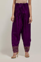 Purple silk narrow salwar with a broad bandhani-inspired border at the hem, detailed with delicate bead and sequin work.