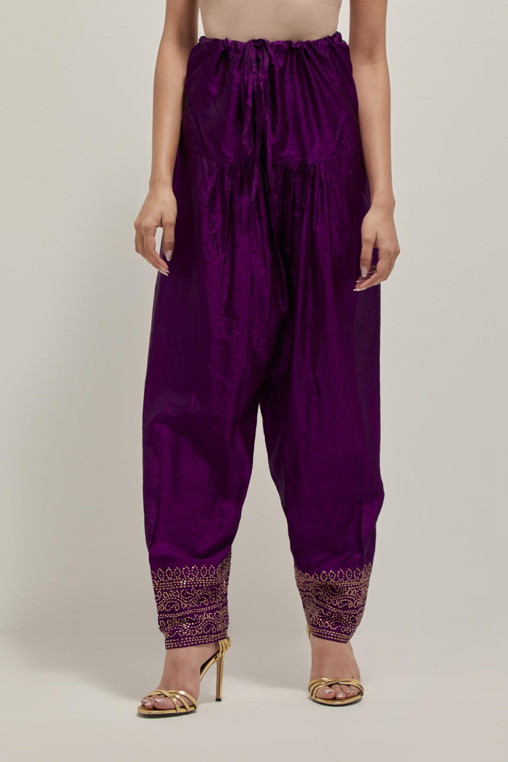 Purple silk narrow salwar with a broad bandhani-inspired border at the hem, detailed with delicate bead and sequin work.
