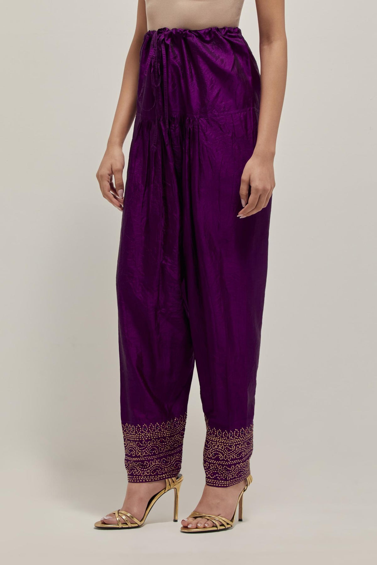 Purple silk narrow salwar with a broad bandhani-inspired border at the hem, detailed with delicate bead and sequin work.