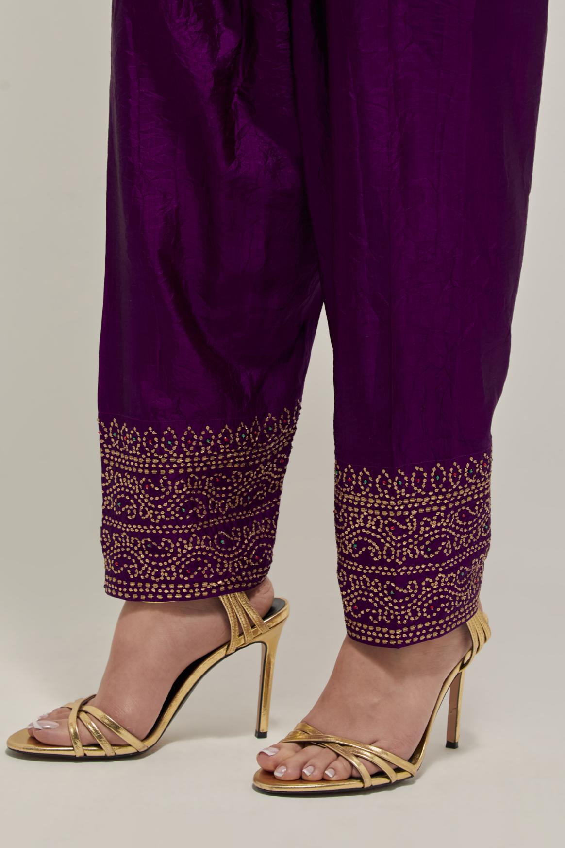Purple silk narrow salwar with a broad bandhani-inspired border at the hem, detailed with delicate bead and sequin work.