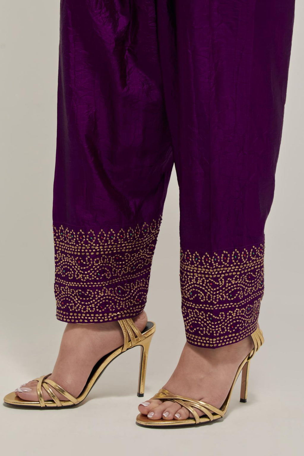 Purple silk narrow salwar with a broad bandhani-inspired border at the hem, detailed with delicate bead and sequin work.