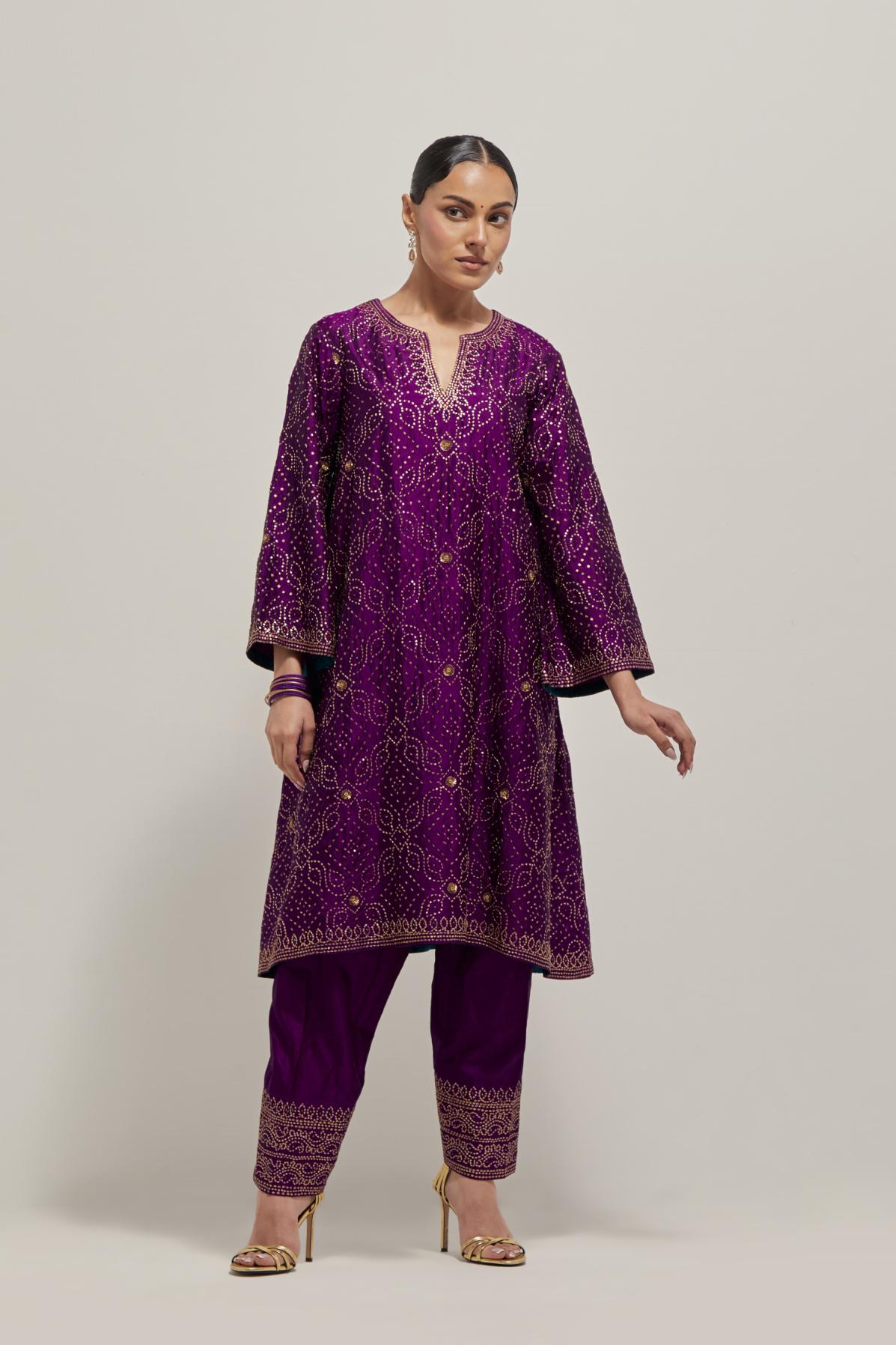 Purple silk A-line kurta set with hand embroidered sequins on bandhani inspired jaal all-over the kurta, highlighted with contrast-colored beads.