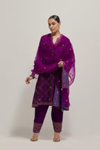 Purple silk A-line kurta set with hand embroidered sequins on bandhani inspired jaal all-over the kurta, highlighted with contrast-colored beads.