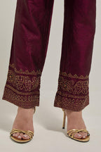 Maroon silk pants with a broad bandhani-inspired border at the hem, detailed with delicate bead and sequin work.