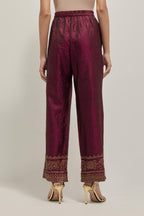 Maroon silk pants with a broad bandhani-inspired border at the hem, detailed with delicate bead and sequin work.