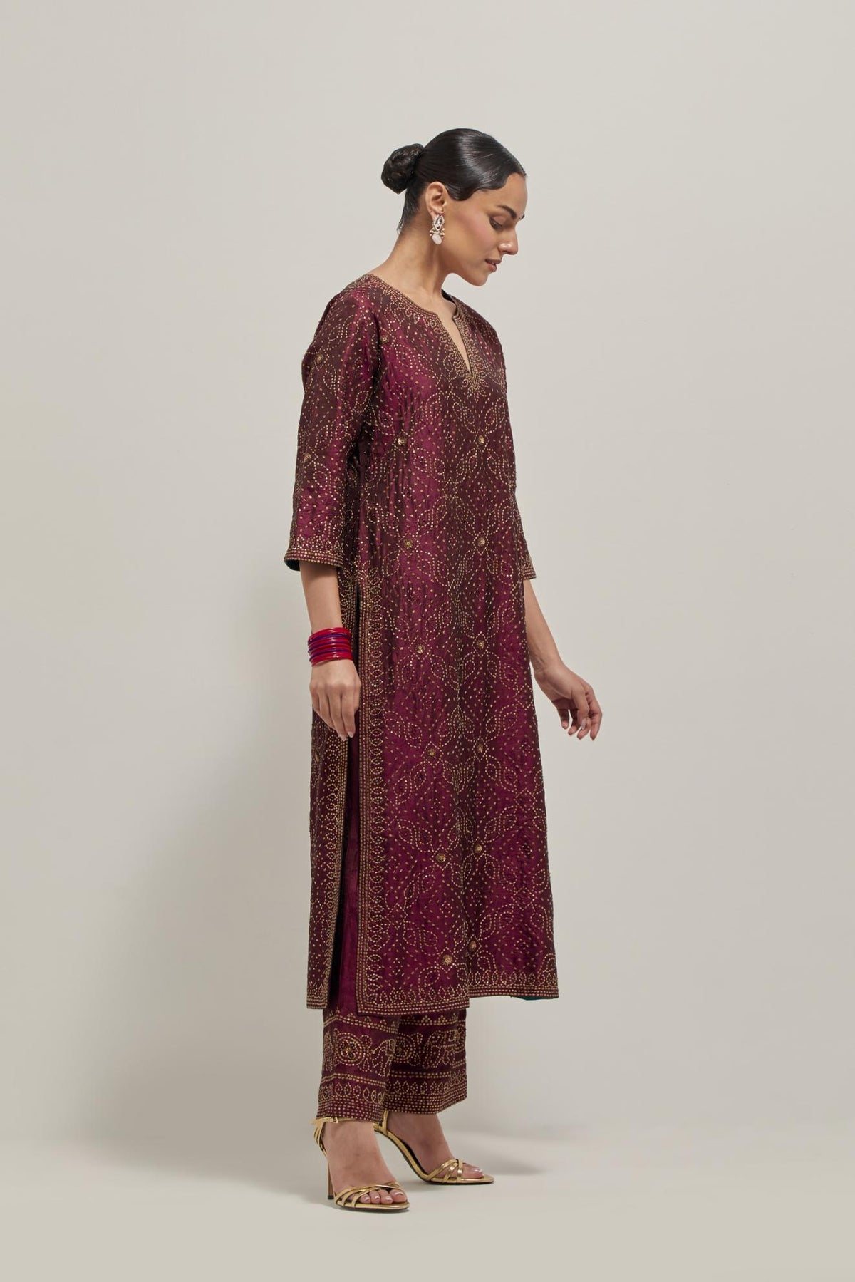 Maroon silk straight kurta set with hand embroidered sequins on bandhani inspired jaal all-over the kurta, highlighted with contrast-colored beads.