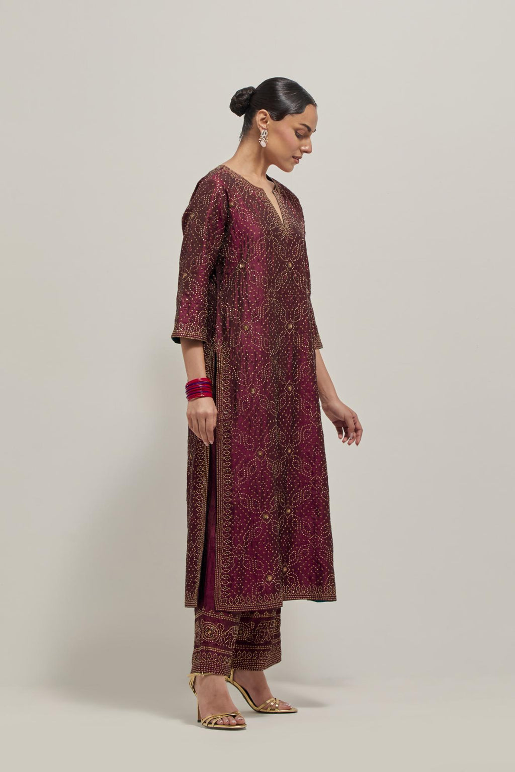 Maroon silk straight kurta set with hand embroidered sequins on bandhani inspired jaal all-over the kurta, highlighted with contrast-colored beads.