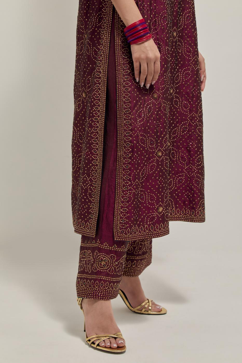 Maroon silk straight kurta set with hand embroidered sequins on bandhani inspired jaal all-over the kurta, highlighted with contrast-colored beads.