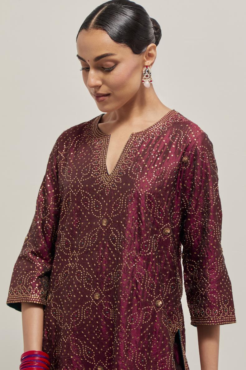Maroon silk straight kurta set with hand embroidered sequins on bandhani inspired jaal all-over the kurta, highlighted with contrast-colored beads.