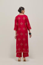 Red silk straight kurta set with all-over hand embroidered sequins on bandhani inspired motifs, highlighted with contrast-colored beads.