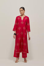 Red silk straight kurta set with all-over hand embroidered sequins on bandhani inspired motifs, highlighted with contrast-colored beads.