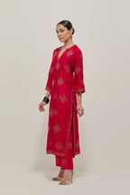 Red silk straight kurta set with all-over hand embroidered sequins on bandhani inspired motifs, highlighted with contrast-colored beads.