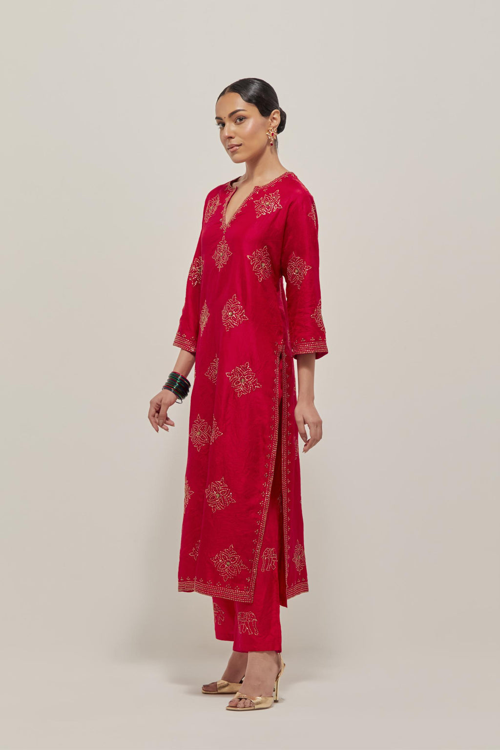Red silk straight kurta set with all-over hand embroidered sequins on bandhani inspired motifs, highlighted with contrast-colored beads.