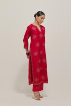 Red silk straight kurta set with all-over hand embroidered sequins on bandhani inspired motifs, highlighted with contrast-colored beads.