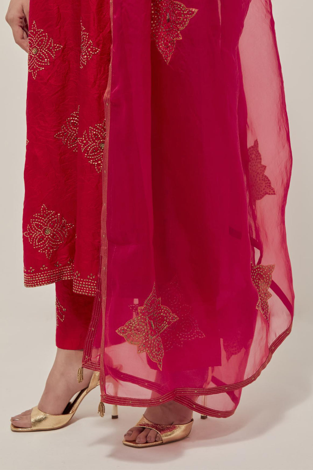 Red silk straight kurta set with all-over hand embroidered sequins on bandhani inspired motifs, highlighted with contrast-colored beads.