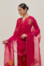 Red silk straight kurta set with all-over hand embroidered sequins on bandhani inspired motifs, highlighted with contrast-colored beads.