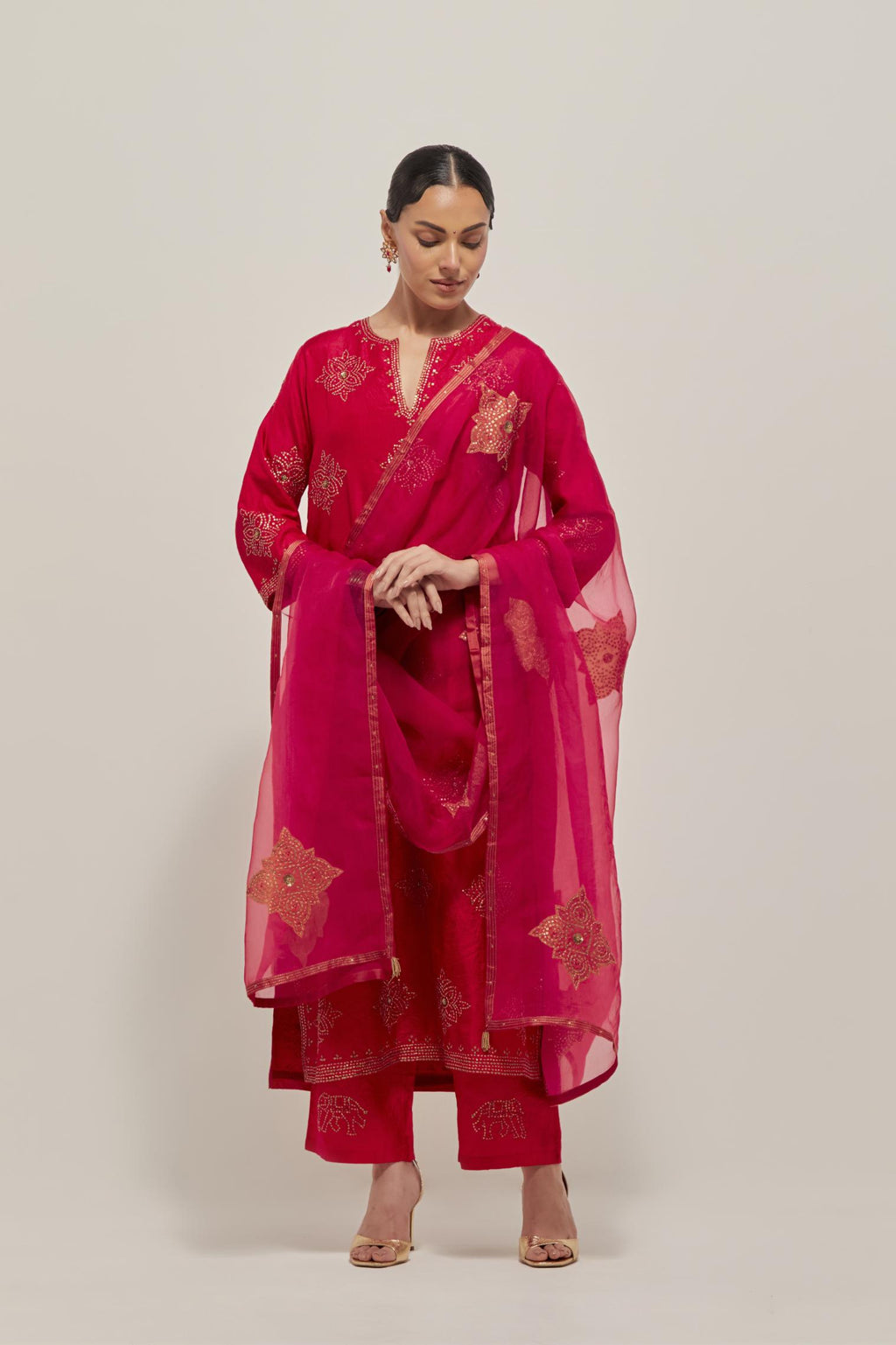 Red silk straight kurta set with all-over hand embroidered sequins on bandhani inspired motifs, highlighted with contrast-colored beads.