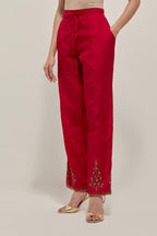 Red Silk pants, highlighted with hand embroidered bead, sequins and zardozi boota at hem, highlighted with contrast bead work.