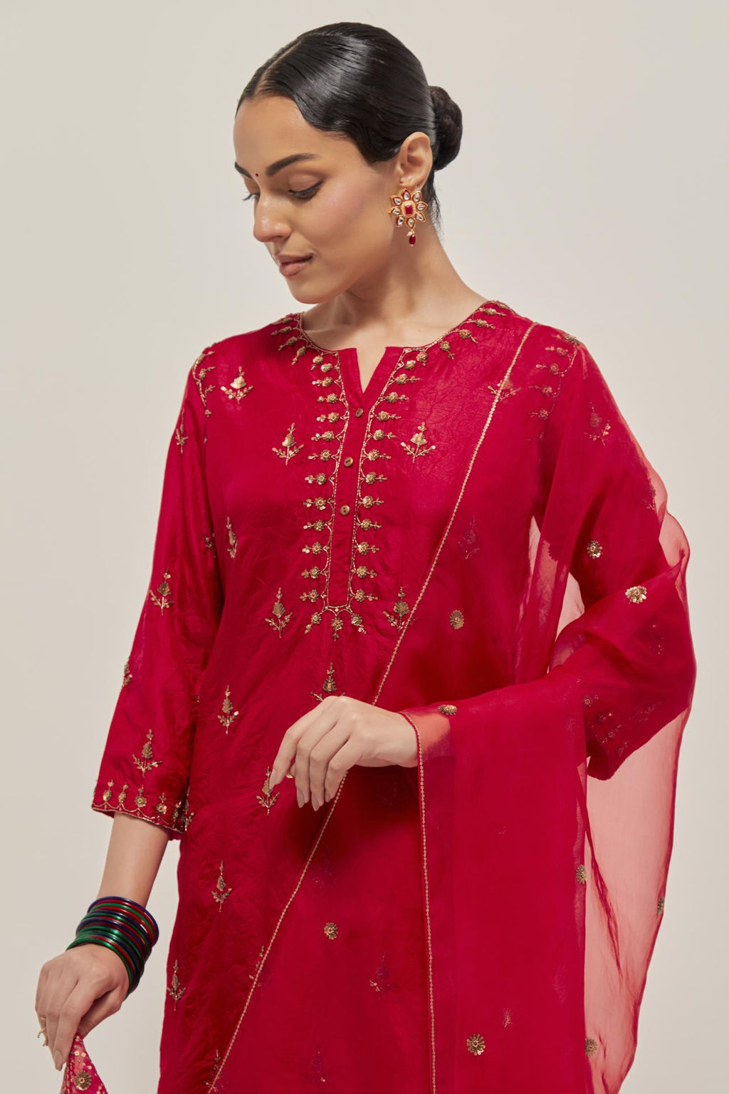 Red silk organza dupatta with all-over delicate sequins and bead small booti, finished with applique bandhani-inspired motifs at all four corners.