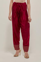 Red silk narrow salwar with a broad bandhani-inspired border at the hem, detailed with delicate bead and sequin work.