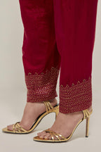 Red silk narrow salwar with a broad bandhani-inspired border at the hem, detailed with delicate bead and sequin work.