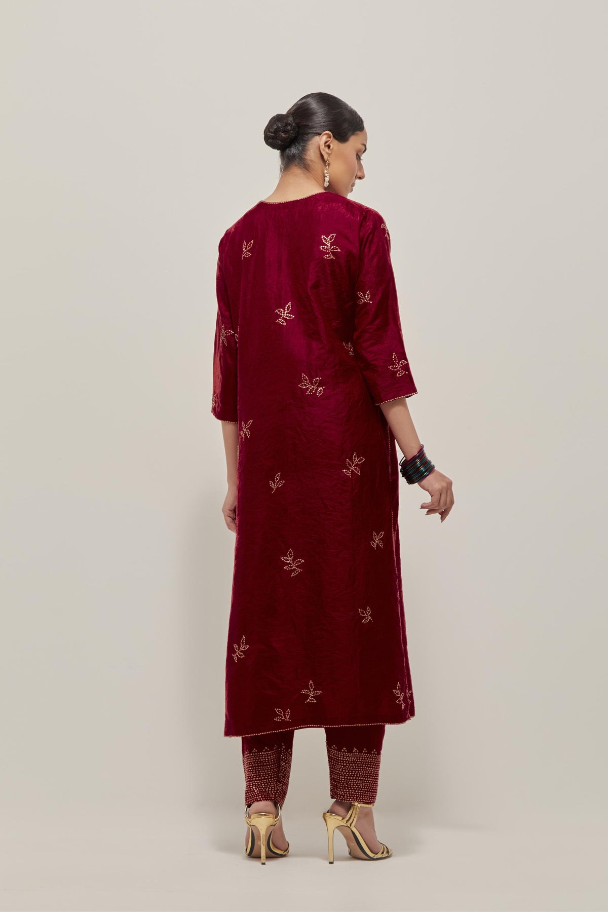 Red Silk kurta set with hand embroidered sequins on bandhani inspired floral motif all-over the kurta, highlighted with contrast-colored beads.
