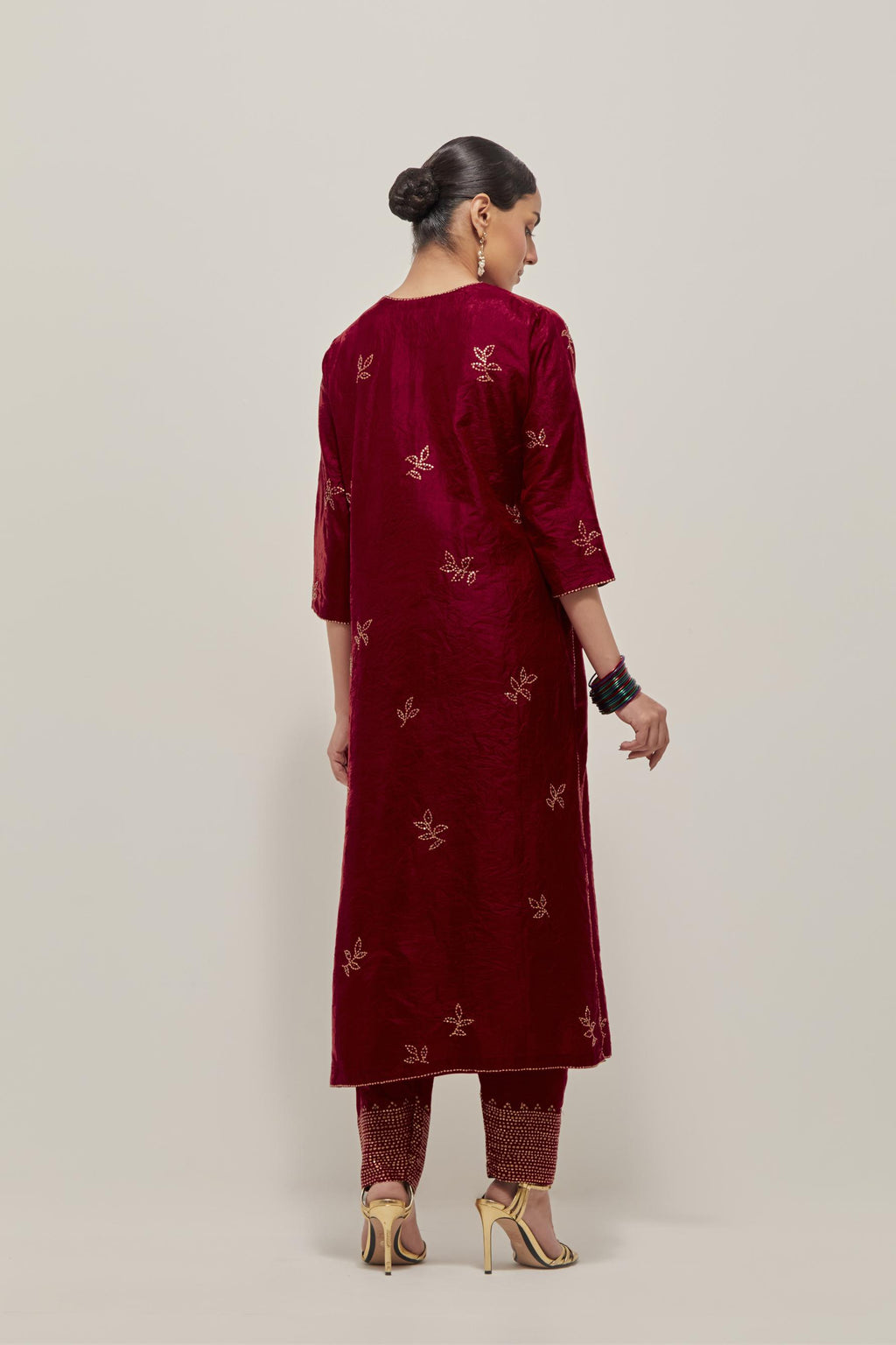 Red Silk kurta set with hand embroidered sequins on bandhani inspired floral motif all-over the kurta, highlighted with contrast-colored beads.