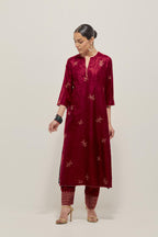Red Silk kurta set with hand embroidered sequins on bandhani inspired floral motif all-over the kurta, highlighted with contrast-colored beads.